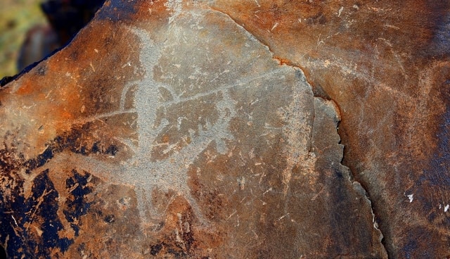 The Person on horse with spear. Petroglyphs the Bayan-Zhurek.