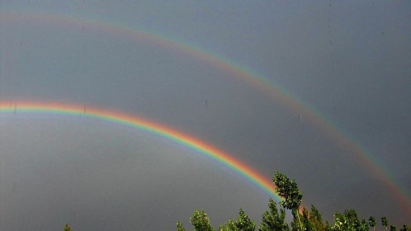 Rainbow in mountains.