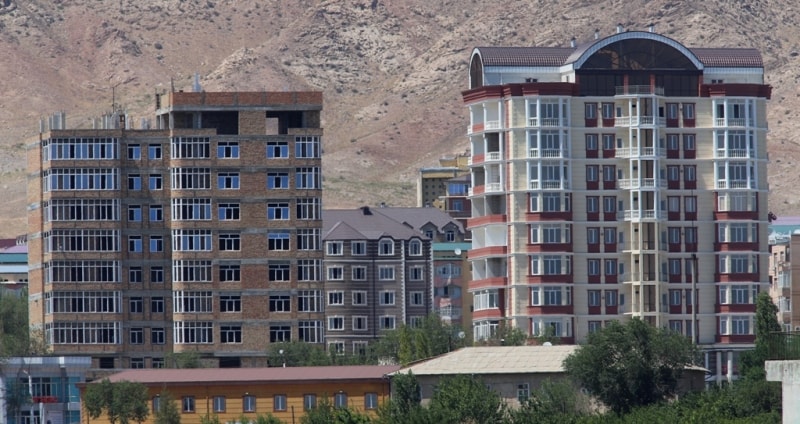 New apartment houses in Khudjand.Mausoleum Kamol Khudjandi in city park of Khudjand.