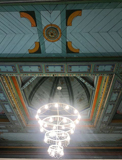 Nogai Ishan Mosque. Decorative wooden ceiling and a modern chandelier. 2024