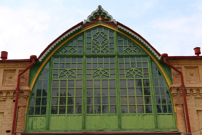 Nogai Ishan Mosque. A rare example of religious architecture that combines traditional forms of Central Asian Islamic architecture with elements of European Art Nouveau. The main façade, a high portal arch, features a large green wooden stained-glass window with a geometric pattern and openwork lattice. The building is constructed of fired brick with natural façade masonry. Slender minarets flank the portal, and a spacious summer prayer hall, an iwan, with carved wooden columns adjoins the building itself. 2024