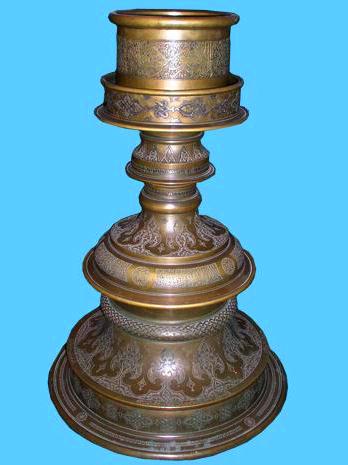 Bronze candlestick on a flat base XIV century. Made by order of Amir Timur for the mausoleum of Khoja Ahmed Yasawi by a master from Isfahan Iz et-Din bin Taj ed-Din June 17, 1397. Height - 86 cm, width - 58 cm.