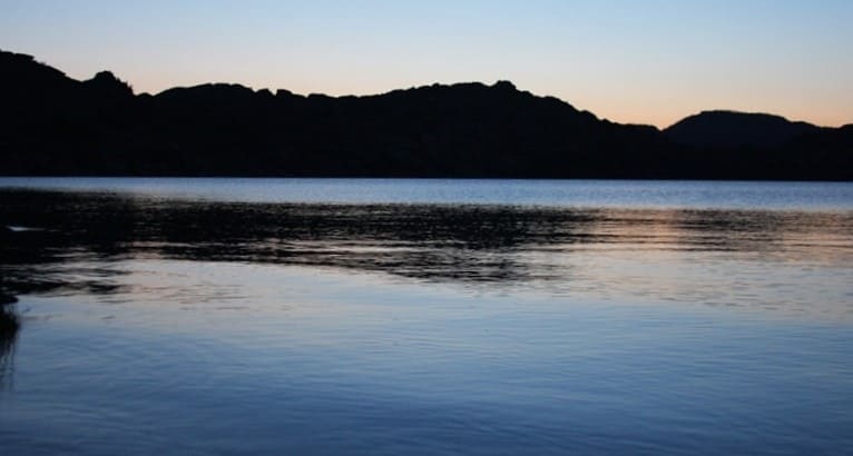 A pine forest against the backdrop of the lakes - the harmony of the taiga and the granite Altai.
