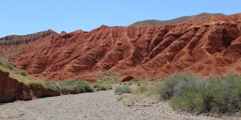 Light and shadow of Kendyrly-Sai. Changing colors of rocks resemble play of sunset fire on face of ancient earth.