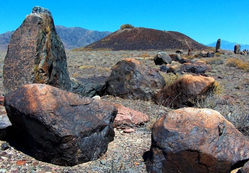 Great Besshatyr burial mound with menhirs in the background.