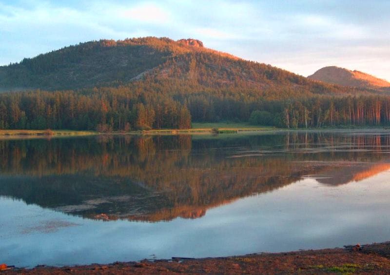 Reflections of mountains and clouds in Lake Komisarovskoye are considered some of most beautiful in Karkaraly.