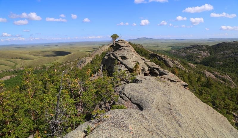 In 1936, 100 young men and women climbed dominant peak of Karkaraly Mountains and named it Komsomol Peak.