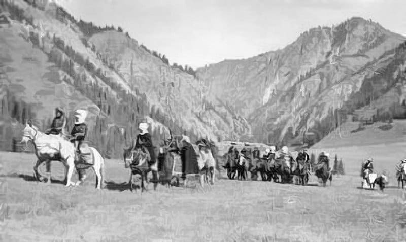 A caravan of horsemen and carts against the backdrop of the Tien Shan mountain landscapes, reflecting the traditional nomadic life of the peoples of Central Asia. Kyrgyz people in traditional clothing and headdresses travel on horseback. The caravan moves through a mountain valley or jailoo. Photographer Max Alper. 1938.