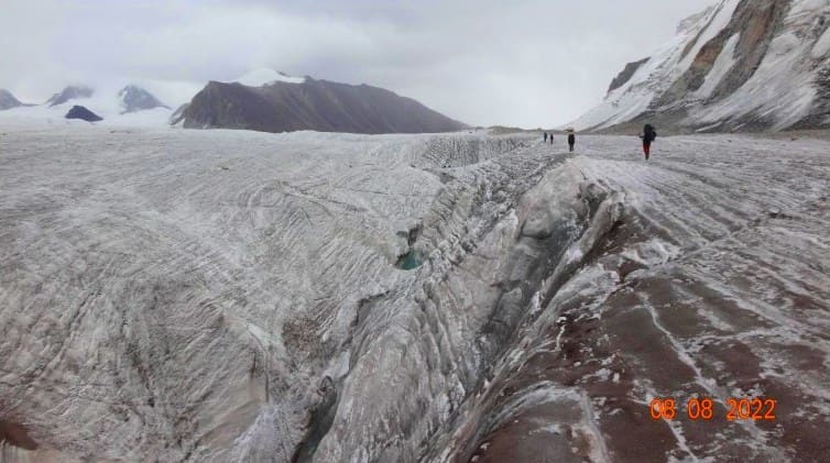 Canyons of ice rivers cutting through the Petrov Glacier. "Report on a third-category sports hike conducted in the Central Tien Shan (Terskey and Akshiyrak ranges) from July 30 to August 13, 2022. Hike leader: Sergey Igorevich Freiman. https://www.geolink-group.com/tourclub/trips/2022sf3/otchet_sf3_2022.pdf