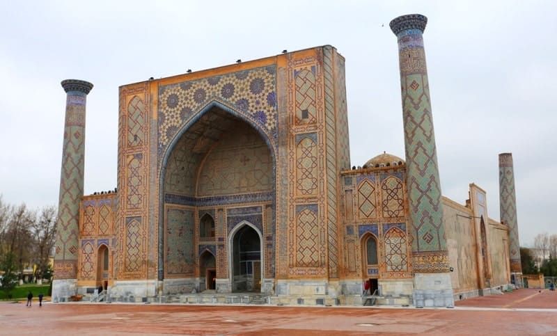 Facade of the Ulugh Beg Madrasah, located on Registan Square in Samarkand. It is the oldest madrasah in the Registan architectural complex, built in the XVth century. The structure was erected by order of the Timurid ruler and eminent astronomer Ulugh Beg.