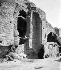Ruins of the Ak-Saray Mausoleum. General view. 1871-1872. This photograph is part of the archaeological section of the "Turkestan Album," a fundamental six-volume photographic study compiled in 1871-1872 under the direction of General K. P. von Kaufman. The mausoleum, built in the 14th-15th centuries, was renowned for its monumental interior painting, known as "kundal" (gilded relief on a blue background). In the foreground, traditional adobe brick houses with flat roofs supported by wooden beams are visible. Photographer N. V. Bogaevsky.