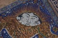 A mosaic pattern adorns the tympanum of the portal of the Sher-Dor Madrasah on Registan Square in Samarkand. It depicts a fantastical beast, reminiscent of a tiger but with a lion's mane, hunting a goitered gazelle. Above the beast's back is a rising sun with a human face. The Sher-Dor Madrasah was built in the 17th century by order of the governor Yalangtush Bahadur.